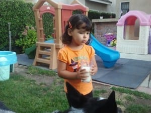 My 2 -in-a-half year old with her glass of milk. However, she was very concerned our dog was going to make her spill it-lol